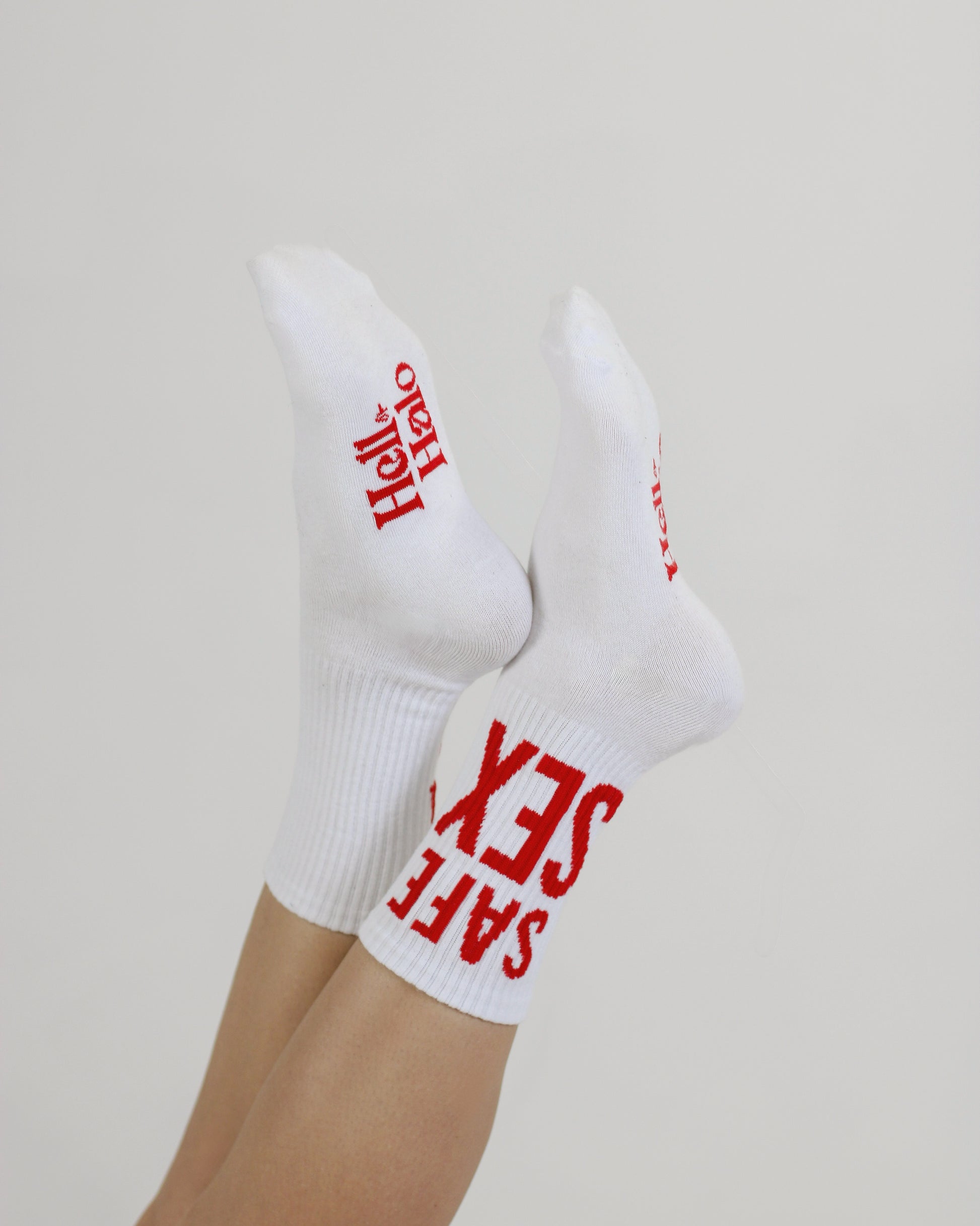 white premium cotton ankle socks for women with bold red lettering fashion socks minimalist studio background
